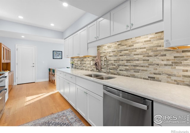 kitchen featuring dishwasher, sink, and white cabinets