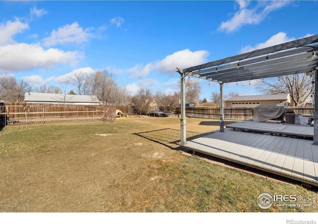 view of yard featuring a wooden deck and a pergola