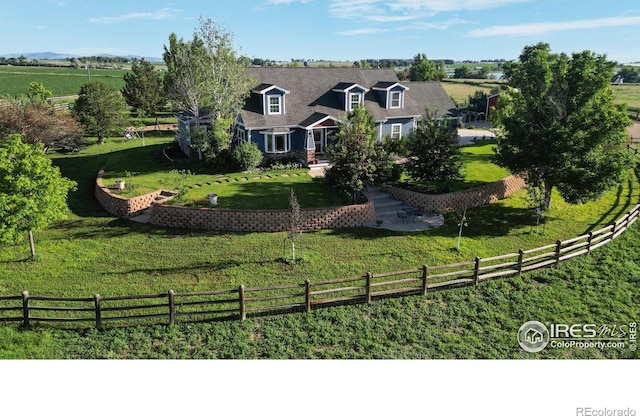 exterior space with a front lawn and a rural view