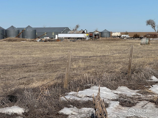 view of yard with a rural view