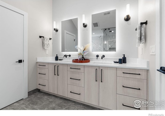 bathroom with vanity and a shower with door