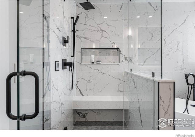 bathroom featuring a shower with shower door