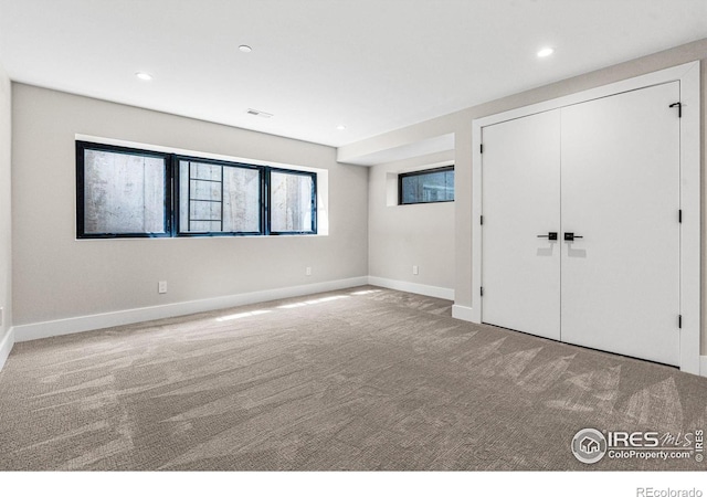 unfurnished bedroom featuring carpet floors and a closet