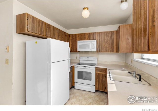 kitchen featuring sink and white appliances