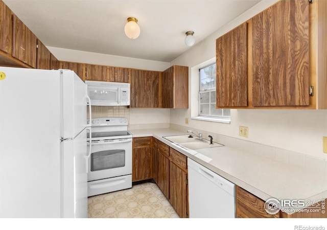 kitchen featuring sink and white appliances