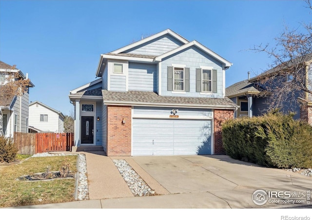 view of front facade with a garage, a shingled roof, concrete driveway, fence, and brick siding