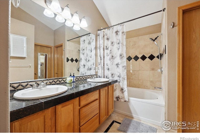 full bath featuring double vanity, tile patterned flooring, shower / bathtub combination with curtain, and a sink