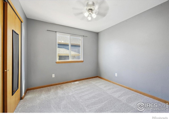 unfurnished bedroom with visible vents, baseboards, ceiling fan, carpet flooring, and a closet