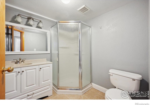 bathroom with tile patterned flooring, toilet, vanity, visible vents, and a stall shower