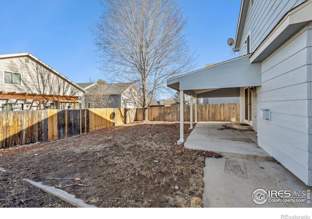 view of yard featuring a patio area and a fenced backyard