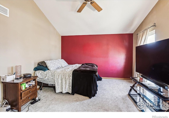 carpeted bedroom with lofted ceiling, ceiling fan, visible vents, and baseboards