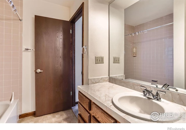 bathroom with vanity and tiled shower / bath combo