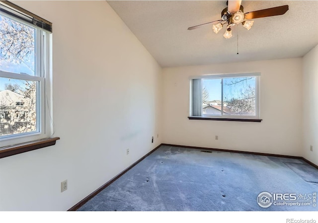 spare room featuring ceiling fan, lofted ceiling, and carpet flooring