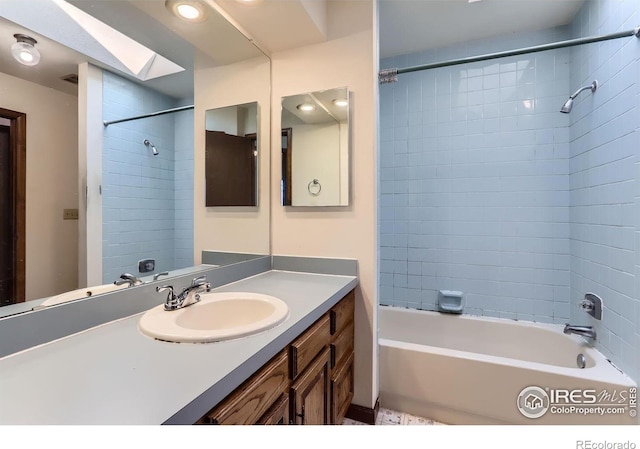 bathroom featuring vanity and tiled shower / bath combo