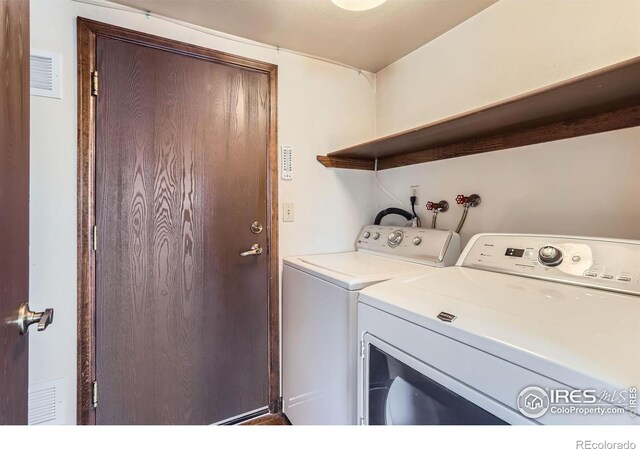 washroom with independent washer and dryer