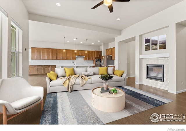 979 Stagecoach Dr, Lafayette, CO 80026 - living area featuring wood finished floors, ceiling fan, a fireplace, baseboards, and recessed lighting