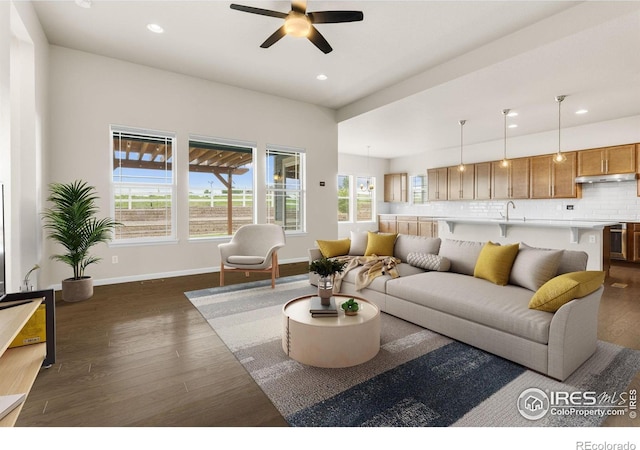 979 Stagecoach Dr, Lafayette, CO 80026 - living area with dark wood-style floors, a ceiling fan, healthy amount of natural light, recessed lighting, and baseboards