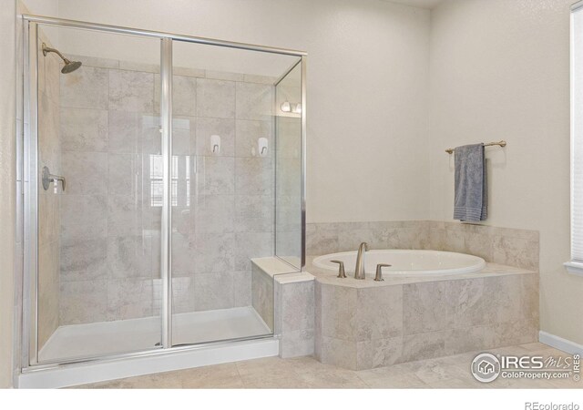 979 Stagecoach Dr, Lafayette, CO 80026 - full bath featuring a shower stall, a garden tub, and tile patterned flooring