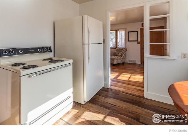 kitchen featuring hardwood / wood-style flooring and white appliances