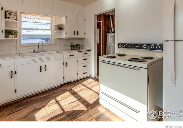 kitchen featuring backsplash, white electric range, sink, and white cabinets