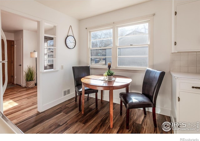 dining area featuring dark hardwood / wood-style flooring