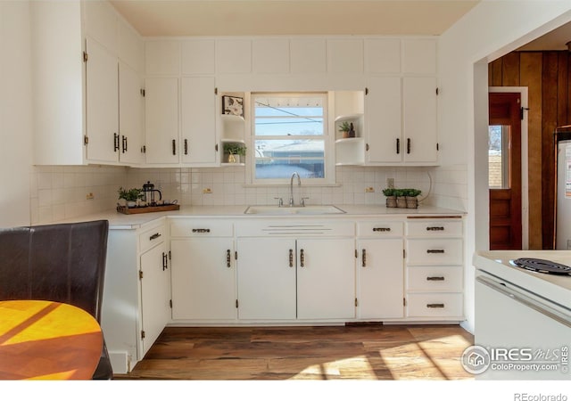 kitchen featuring sink, decorative backsplash, and white cabinets