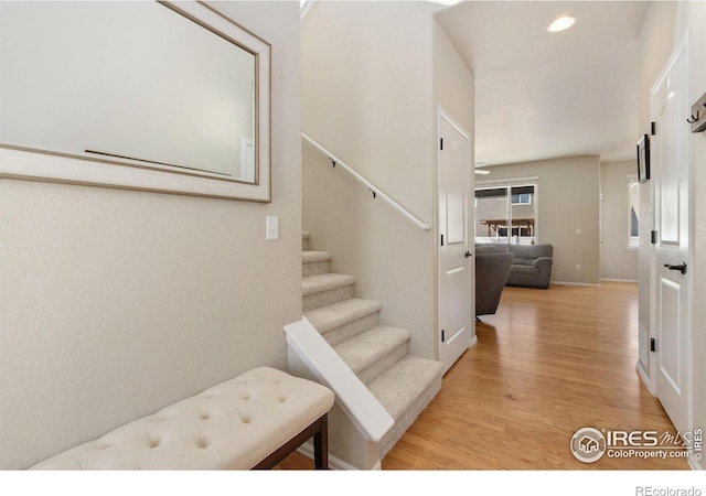 stairs with wood-type flooring