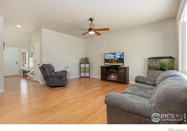 living room featuring light hardwood / wood-style floors and ceiling fan