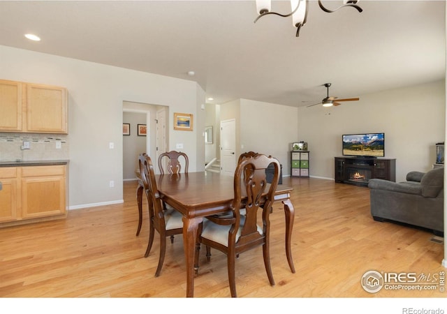 dining space featuring ceiling fan and light wood-type flooring