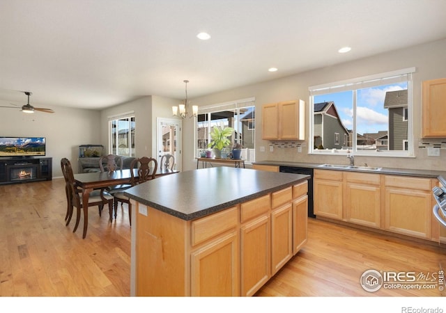 kitchen with pendant lighting, a center island, black dishwasher, and light hardwood / wood-style floors