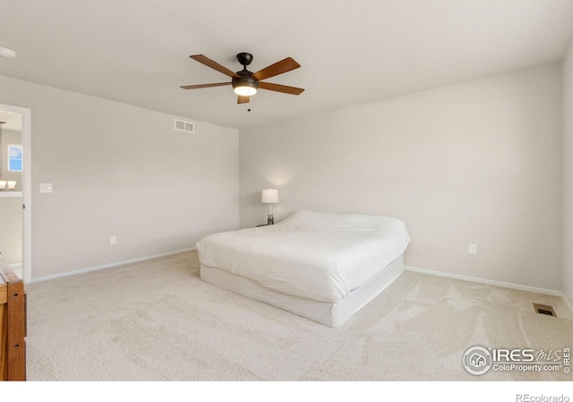 unfurnished bedroom featuring light colored carpet and ceiling fan