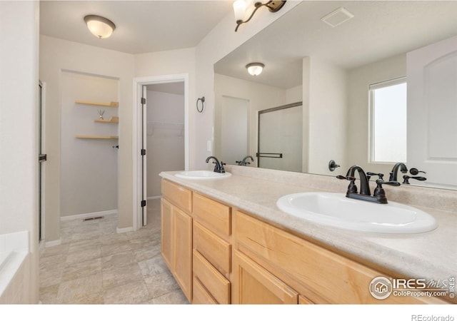 bathroom featuring vanity and a shower with shower door