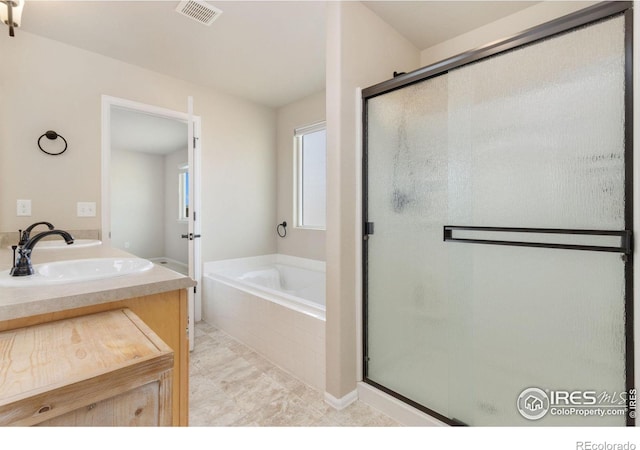 bathroom with plus walk in shower and vanity