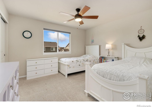 bedroom featuring light carpet, a closet, and ceiling fan