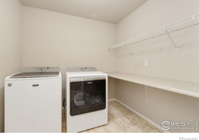 clothes washing area featuring separate washer and dryer