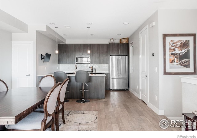 dining space with light hardwood / wood-style floors