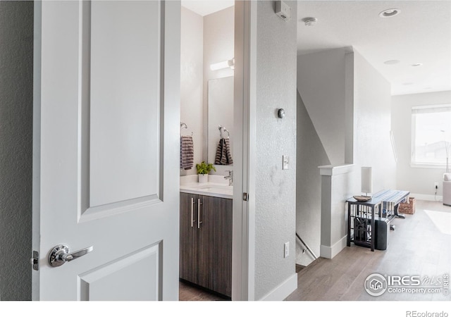 bathroom with vanity and wood-type flooring