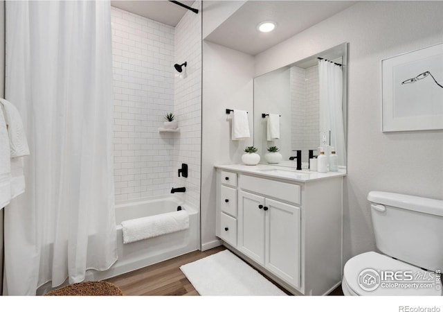 full bathroom with vanity, hardwood / wood-style floors, shower / tub combo, and toilet