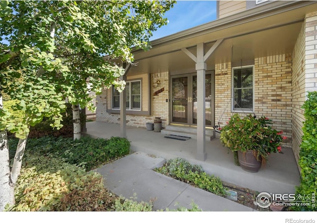 view of exterior entry with covered porch