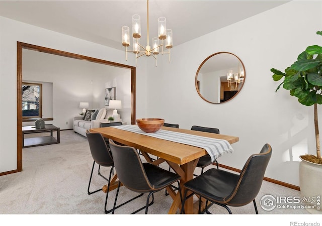 dining room featuring light carpet and a notable chandelier