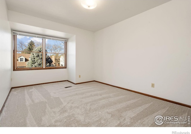 empty room with light colored carpet