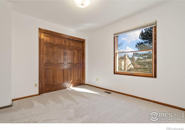 unfurnished bedroom featuring light carpet