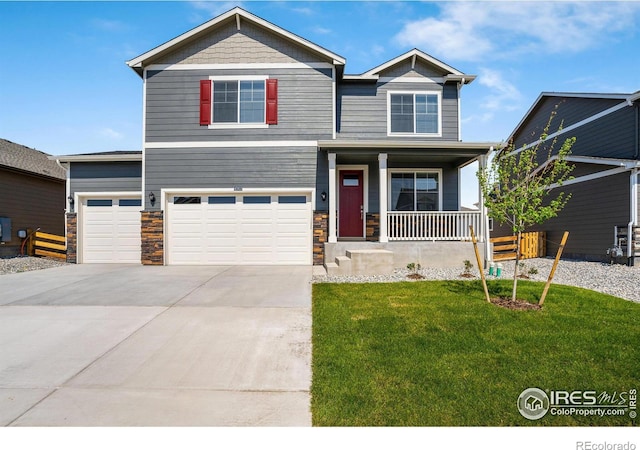 craftsman-style home with a garage, covered porch, and a front lawn