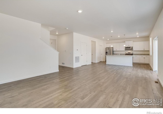 unfurnished living room with light hardwood / wood-style flooring