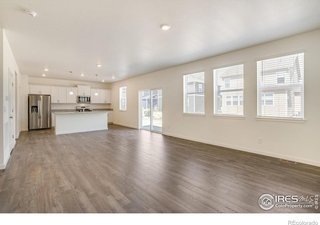 unfurnished living room featuring hardwood / wood-style floors