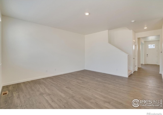 empty room with light hardwood / wood-style floors