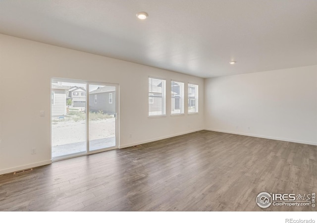 spare room with wood-type flooring