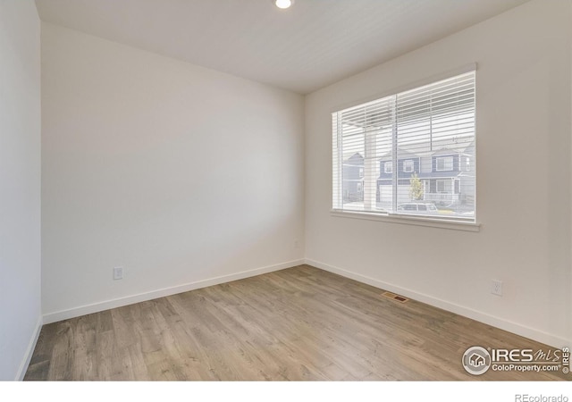 unfurnished room featuring light wood-type flooring