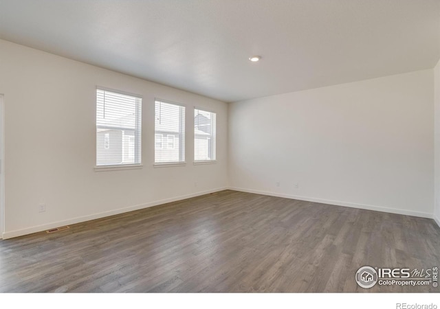 empty room featuring dark wood-type flooring