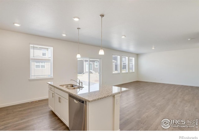 kitchen with sink, decorative light fixtures, stainless steel dishwasher, a kitchen island with sink, and white cabinets